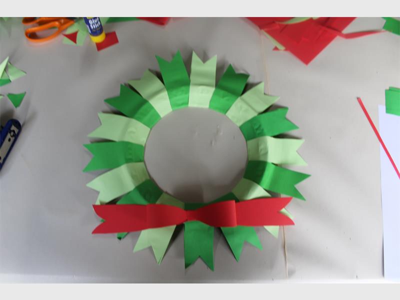 red bow glued to paper wreath