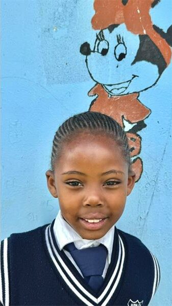 little girl wearing a navy blue school pull-over