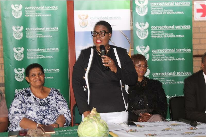woman speaks over a microphone