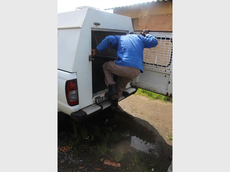 a man gets into the back of a law enforcement van