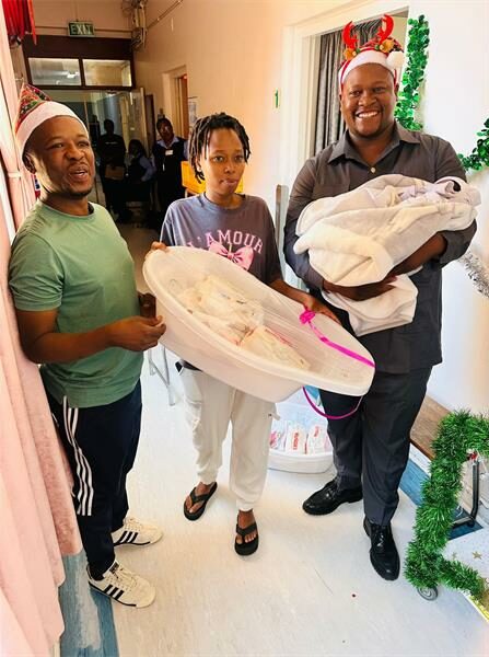 two men with baby and mother