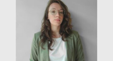 woman with long hair against a grey background