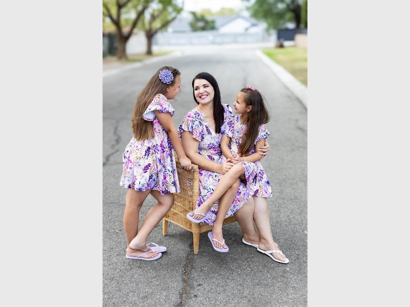 woman and two girls in similar outfits