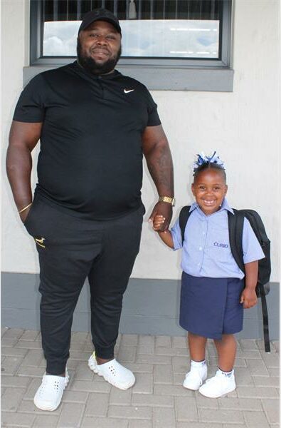 man with his little daughter at school