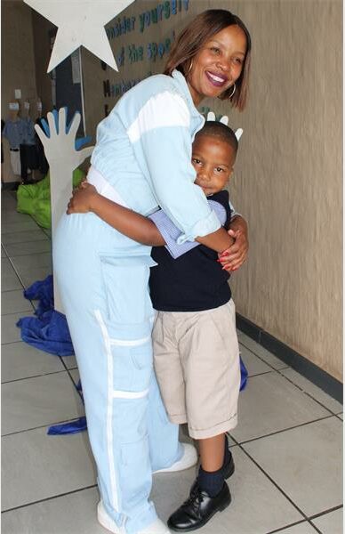 a woman hugs her son at school