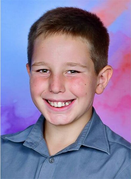 school boy with blue and pink background