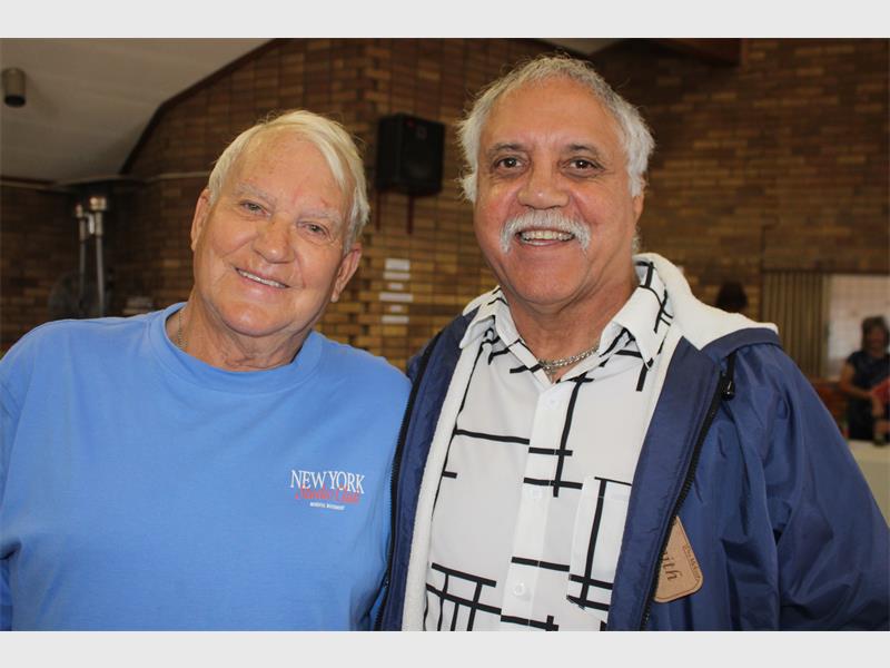 two elderly men smiling