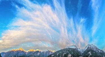 photo of cloud formation over a mountain