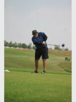 man with beard plays golf