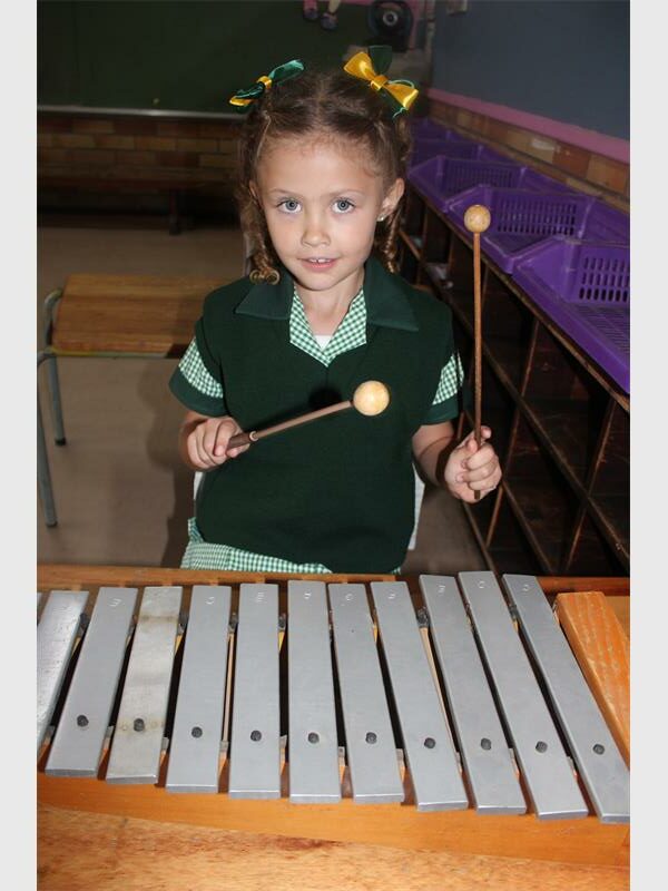 girl playing a xylophone