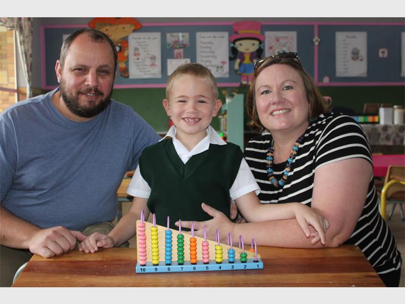 boy and parents on his first day of school