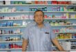 indian man in front of medicine cabinet