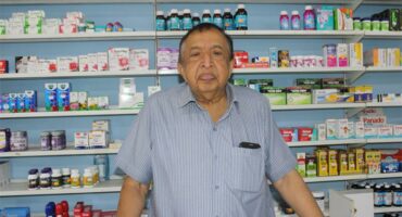 indian man in front of medicine cabinet