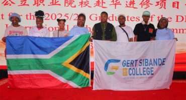 eight people in a line holding up SA flag
