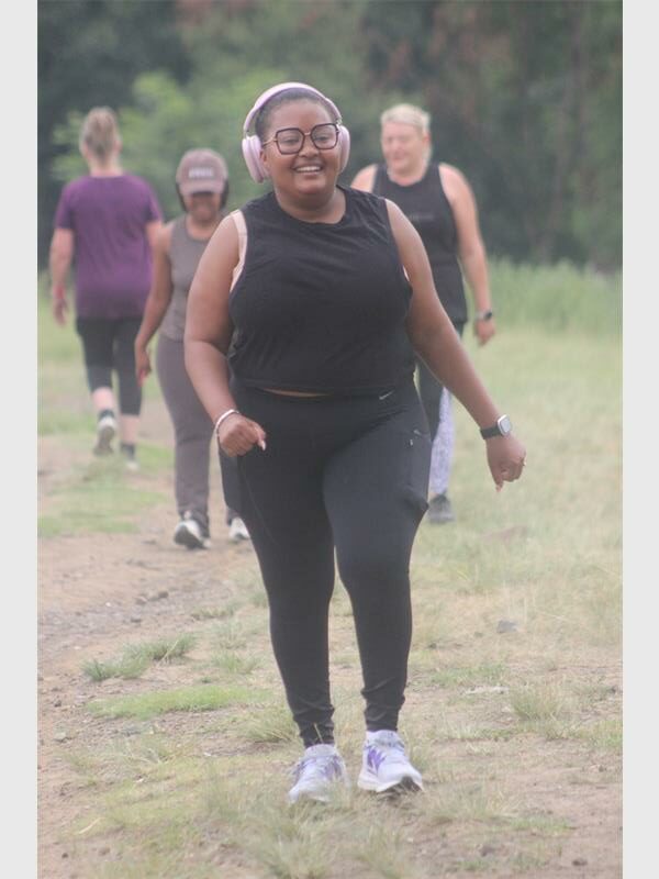 woman in black sport wear with earphones