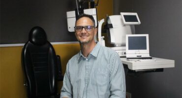 man in front of eye testing equipment