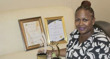 woman with trophies and certificates