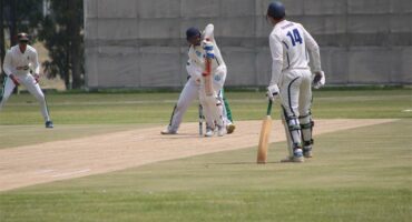 Batsman on cricket pitch
