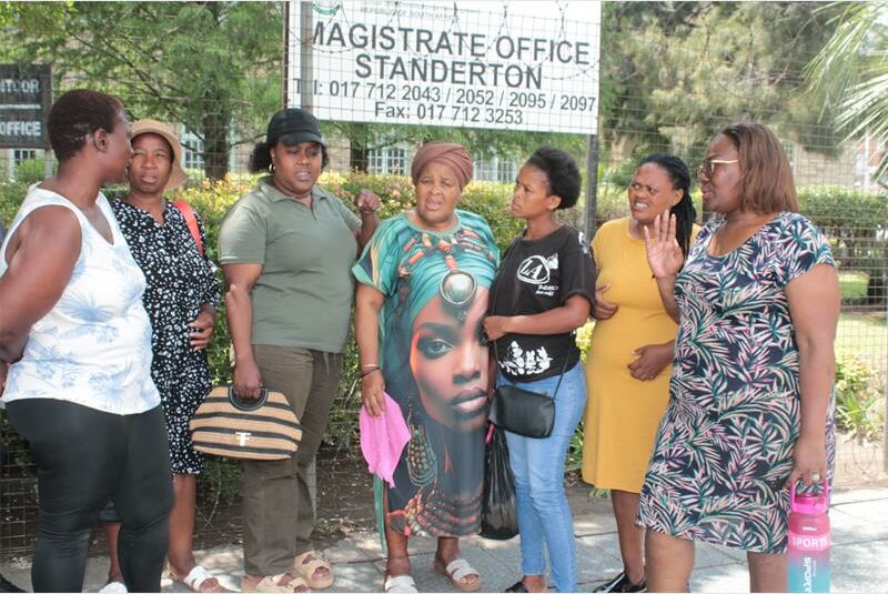 people gather outside the court
