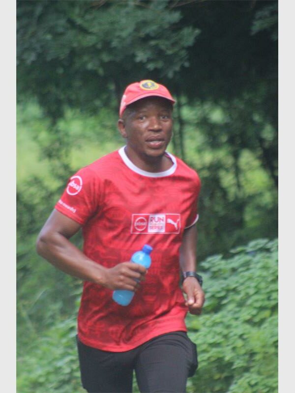 running man wearing a red shirt and cap