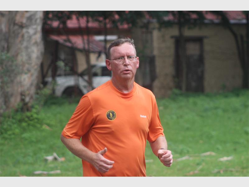 man in orange shirt runs