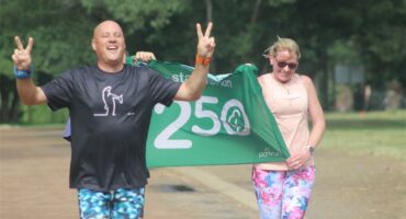 running man with a 250 banner behind him