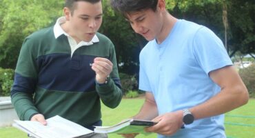 two boys look at text books