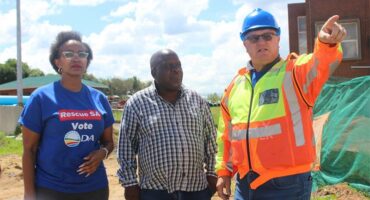 three people on a building site