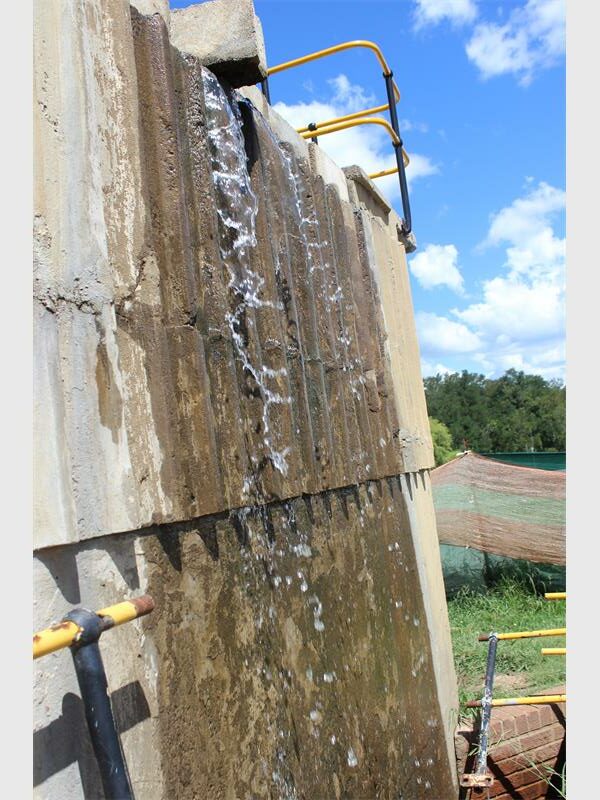 water runs down a concrete wall