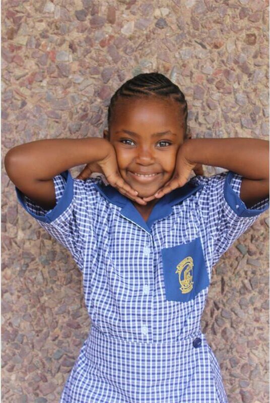 little girl in blue patterned school dress
