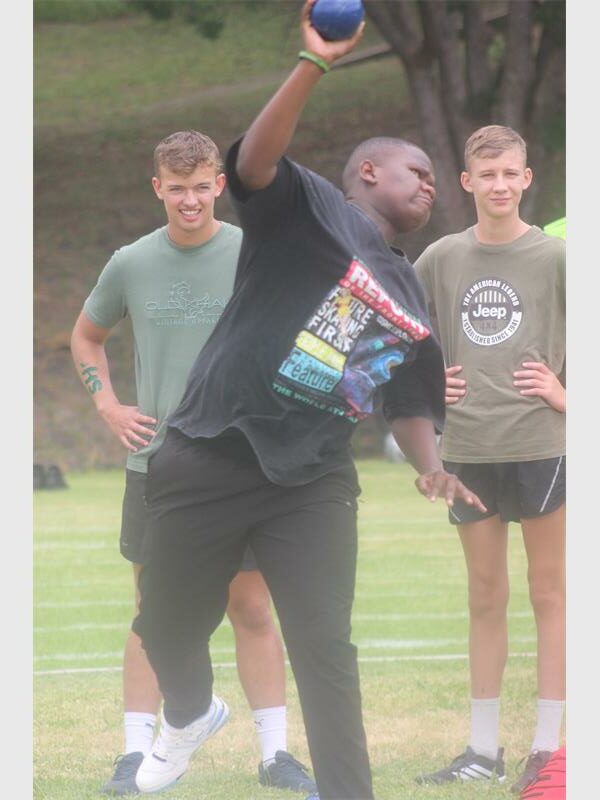 boy represents the black team in the shot put item
