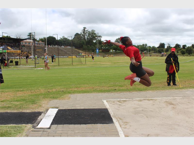 girl takes part in long jump for red team