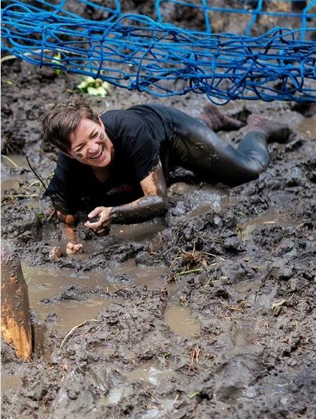 woman crawls in the mud