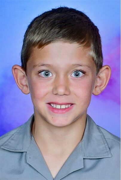blue eyed boy in school uniform