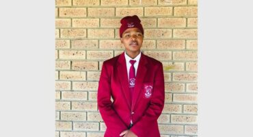 girl with red school blazer and a beanie on her head