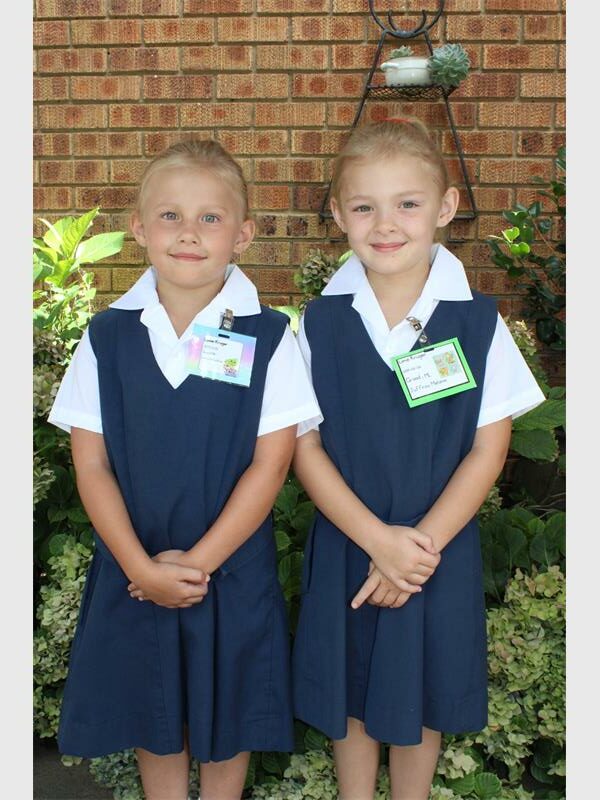 twin girls in blue school uniforms