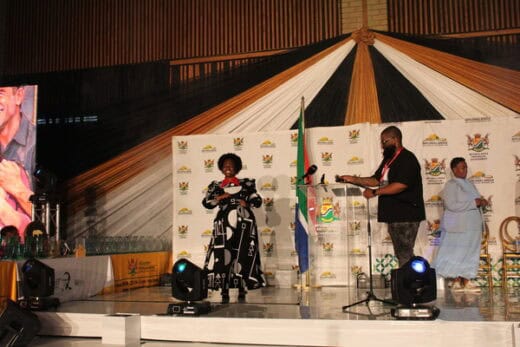 woman on stage with SA flag