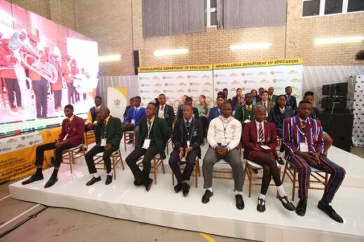 learners sitting on a stage