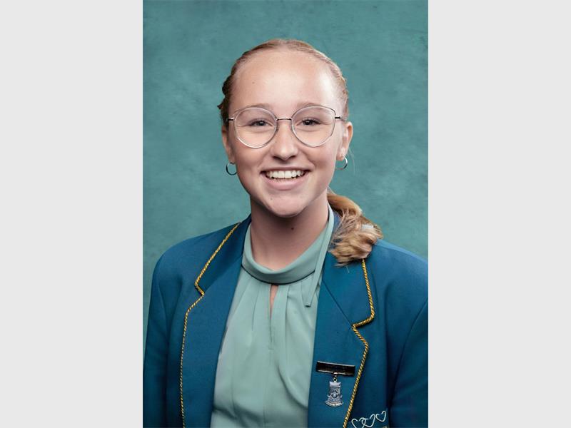 blond girl with glasses in a school uniform