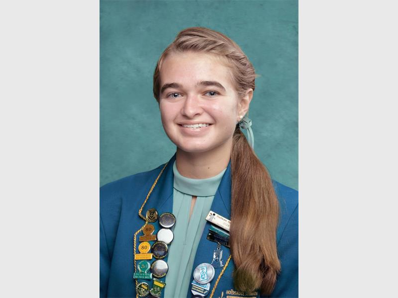 girl with turquois bow in her hair and school uniform
