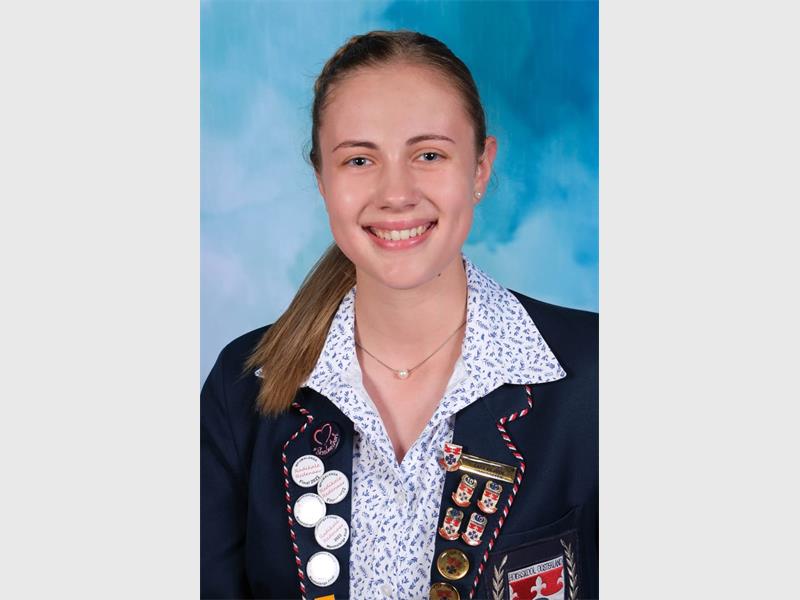 girl with polka dot blouse and navy blaser