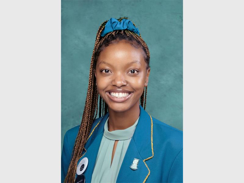girl in school uniform with blue scrunchie in her braids