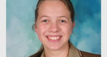 girl with ponytail and school uniform with blue background