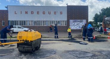 workers fill potholes