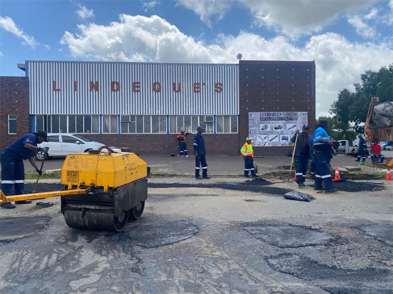 workers patching potholes