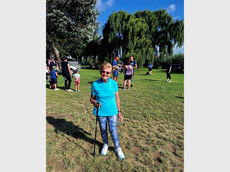 woman in blue with walking stick