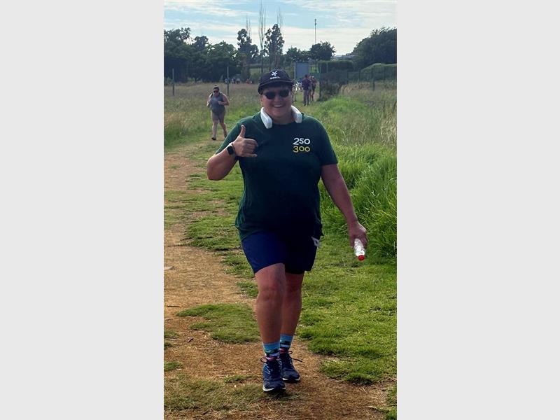 A woman in black walking outdoors