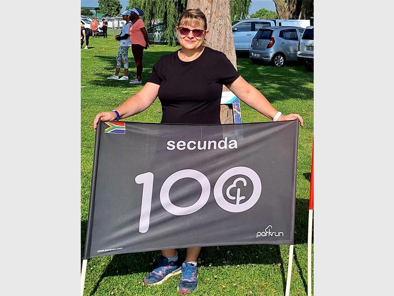 Woman with a 100 banner