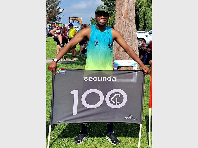 man with a 100 banner
