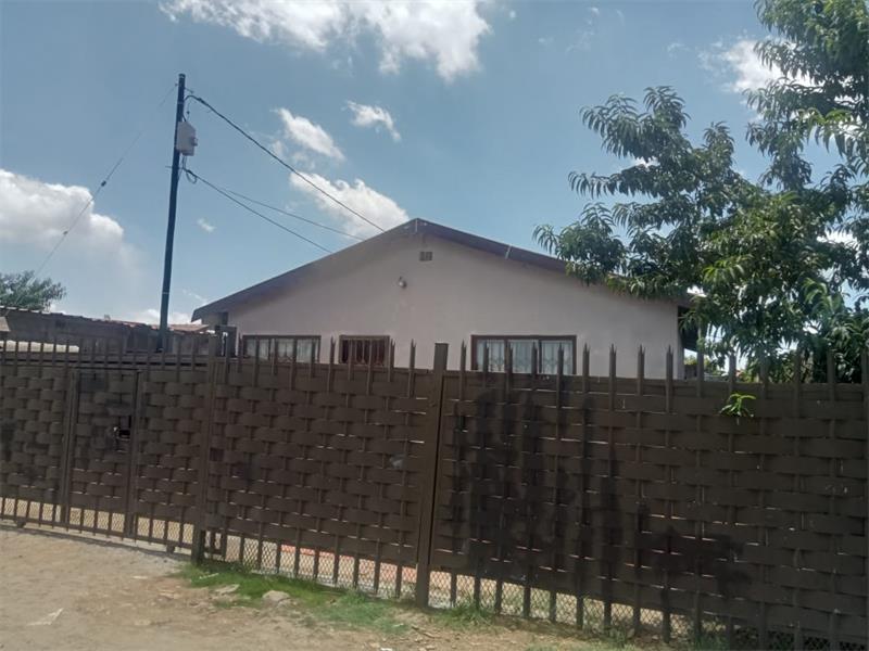 house with electricity pole in yard